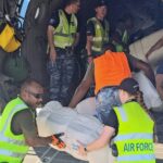 Ground crew and members of the Royal Australian Air Force load boxes of aid onto a C-130 Hercules aircraft in Port Moresby on May 29, 2024 before heading to the site of a landslide at Mulitaka village in the region of Maip Mulitaka, in Papua New Guinea's