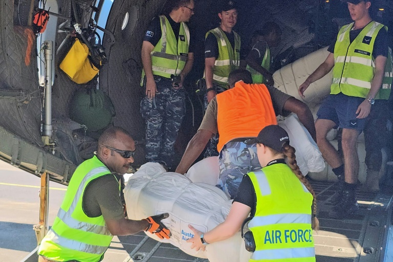 Ground crew and members of the Royal Australian Air Force load boxes of aid onto a C-130 Hercules aircraft in Port Moresby on May 29, 2024 before heading to the site of a landslide at Mulitaka village in the region of Maip Mulitaka, in Papua New Guinea's