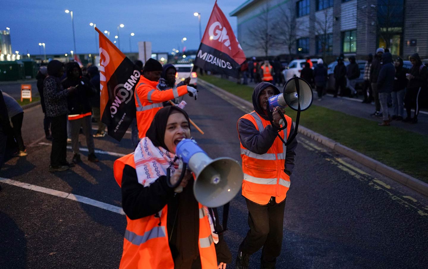 Members of the GMB union who work at Amazon picket outside the online retailer's site in Coventry.