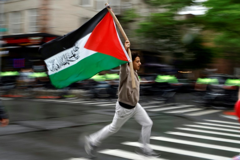 A pro-Palestinian demonstrator runs with a Palestinian flag during a rally in New York earlier this week