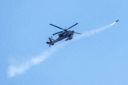 An Israeli Air Force attack helicopter firing a missile while flying over the Palestinian territory on May 15, 2024