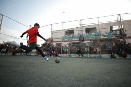 Taking a shot on goal during a soccer game in Rafah