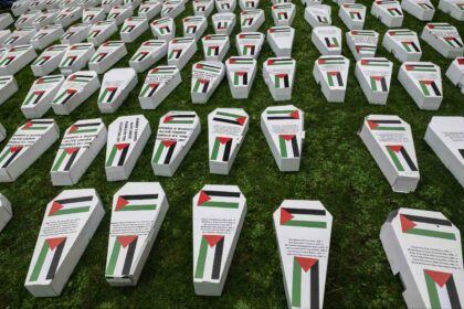 Symbolic coffins are laid out as Health Workers for Palestine march from St Thomas