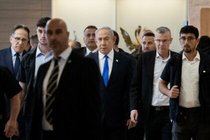 Israeli Prime Minister Benjamin Netanyahu (C) arrives for a party meeting at the Israeli parliament, the Knesset, in Jerusalem on May 20, 2024. Israel on May 20 slammed as a "historical disgrace" an application by the prosecutor of the International Criminal Court for an arrest warrant for Netanyahu.