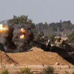 An Israeli mobile artillery unit fires toward Gaza from southern Israel
