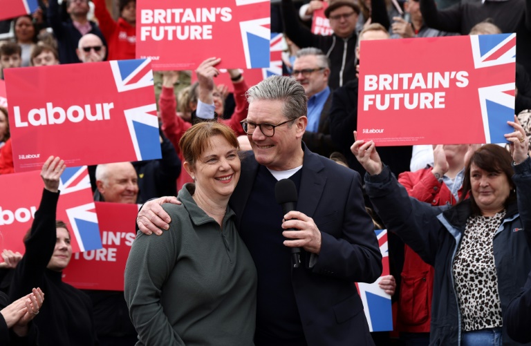 Britain's main opposition Labour Party leader Keir Starmer embraces newly elected East Midlands Mayor Claire Ward