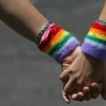 In this photo, A lesbian couple hold hands during the annual Gay Pride rally.