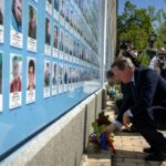 Cameron lays flowers at a memorial wall to servicemen killed defending Russia's attack during a visit Kyiv this month