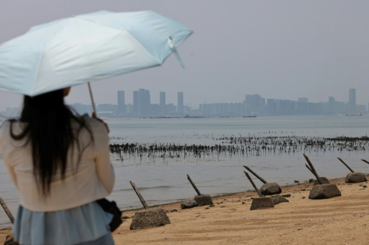 For the best view of Xiamen's skyscrapers, visitors stand on a beach on Kinmen where anti-landing spikes jut out