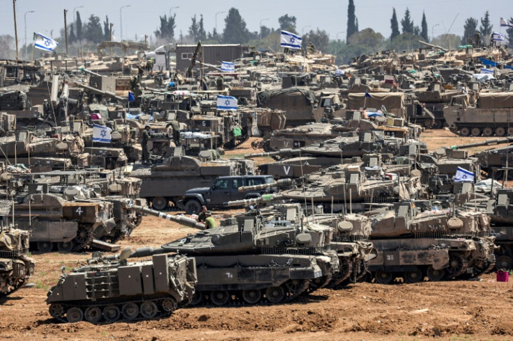Israeli army main battle tanks and other military vehicles are positioned in southern Israel near Gaza
