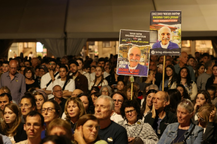 Israelis carry posters with images of hostages held in Gaza at a rally in Tel Aviv on Holocaust Remembrance Day