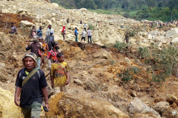 Locals gather at the site of a landslide at Mulitaka village in the region of Maip Mulitaka, in Papua New Guinea's Enga Province on May 26, 2024. More than 670 people are believed dead after a massive landslide in Papua New Guinea, a UN official told AFP 