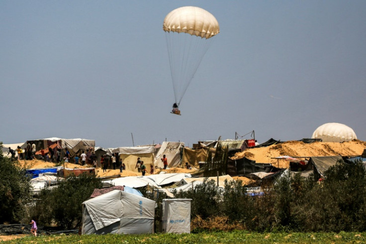 Air-dropped humanitarian aid lands at Gaza's Khan Yunis near tents sheltering Palestinians displaced by the conflict