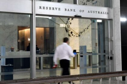 Aust shares edge lower at noon as RBA meeting kicks off
