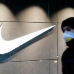 A man wearing a protective face mask amid the outbreak of the coronavirus disease (COVID-19) walks past a Nike brand store in central Kyiv, Ukraine December 10, 2020.