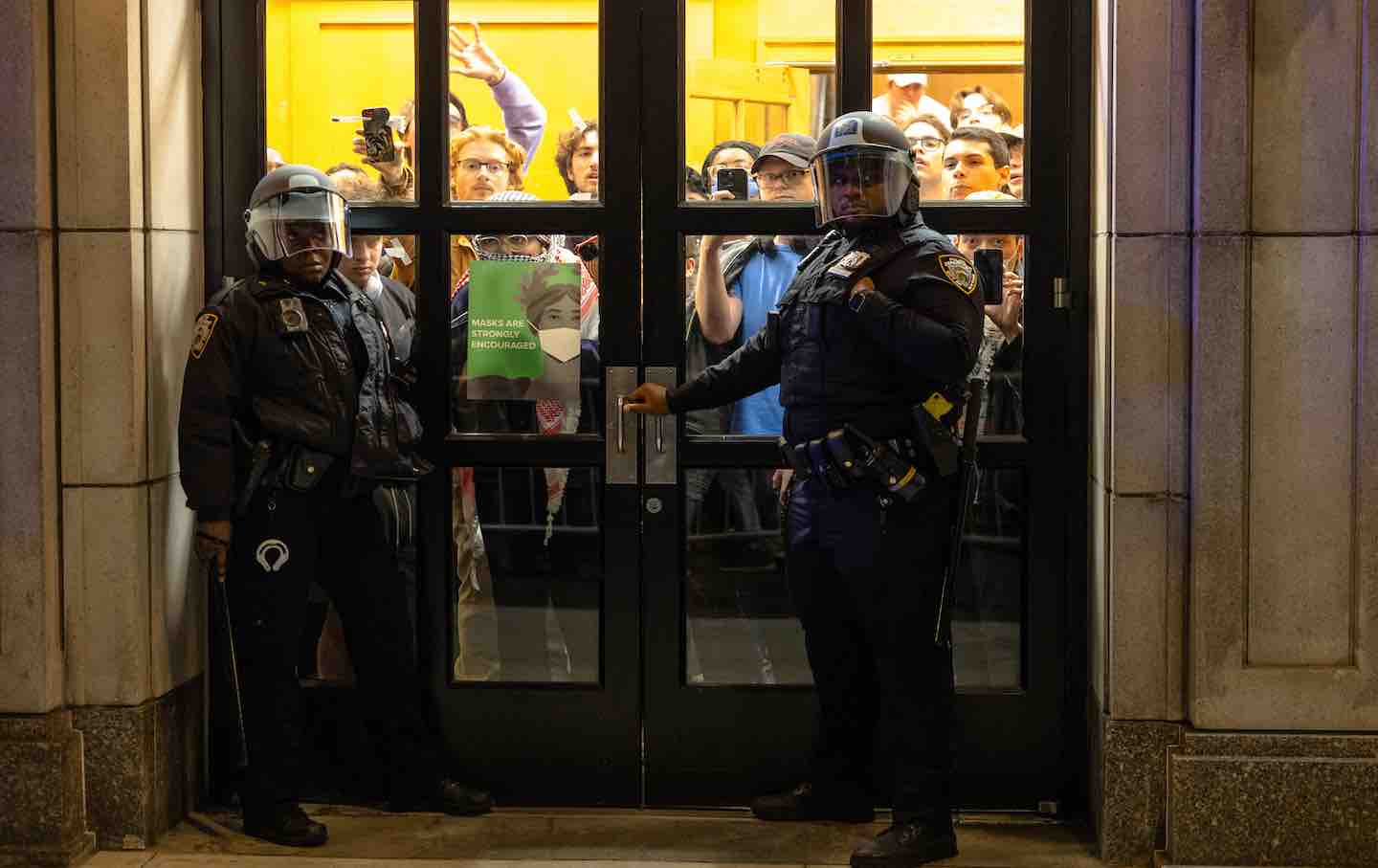 New York City police officers preparing to enter Columbia University's Hamilton Hall, 2024.