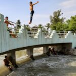 A boy jumps into a canal of the Tigris river in Baghdad amid soaring temperatures this week