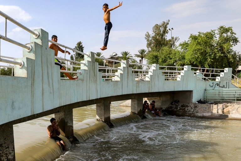 A boy jumps into a canal of the Tigris river in Baghdad amid soaring temperatures this week