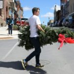 A set decorator carries a Christmas tree during filming of 'Hocus Pocus Christmas' on April 16 in Almonte, Ontario, just outside Ottawa