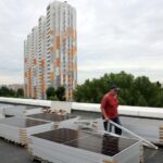A worker installs solar panels during a blackout in Kyiv