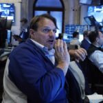 Wall St ends lower as investors digest inflation data