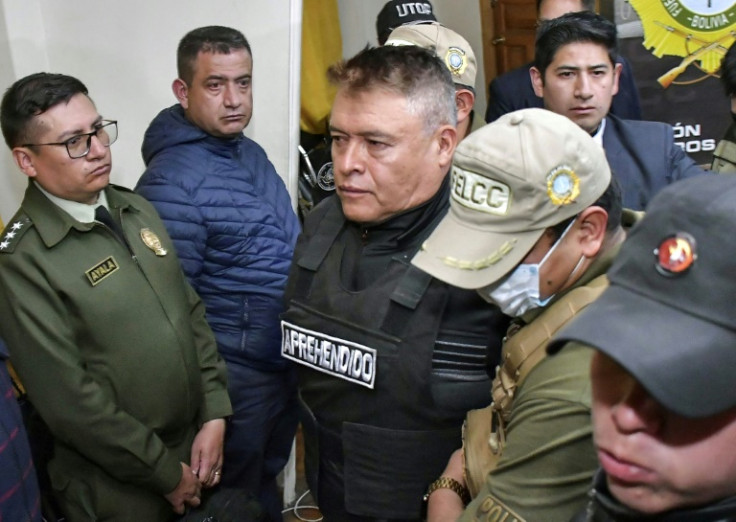 Bolivia's rebel army chief General Juan Jose Zuniga (C) is escorted by policemen following his arrest