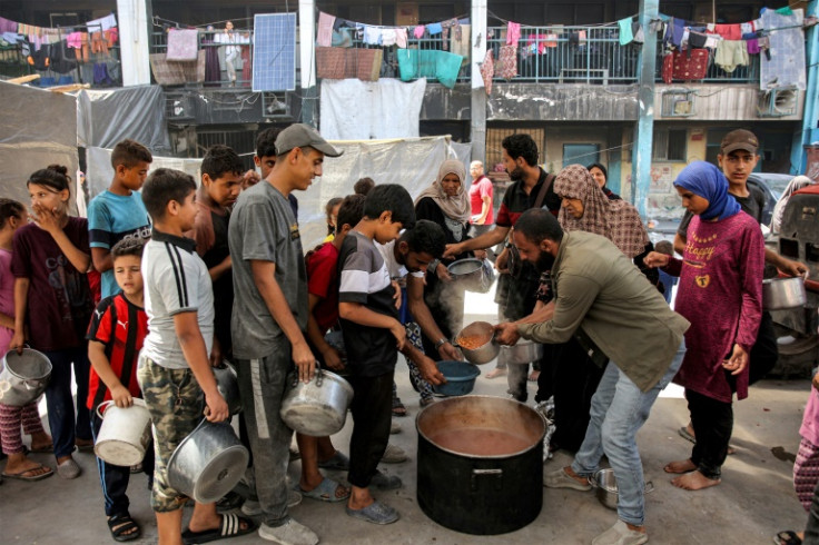 Gazans queue for food aid at a UN-run school in north Gaza's Jabalia refugee camp