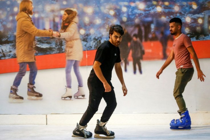 Iraqis skate at the Zayouna Mall ice skating rink in the capital Baghdad