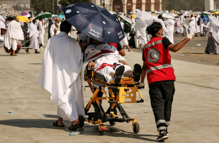 Medical team members evacuate a Muslim pilgrim, affected by the soarching heat, at the base of Mount Arafat, also known as Jabal al-Rahma or Mount of Mercy, during the annual hajj pilgrimage on June 15, 2024