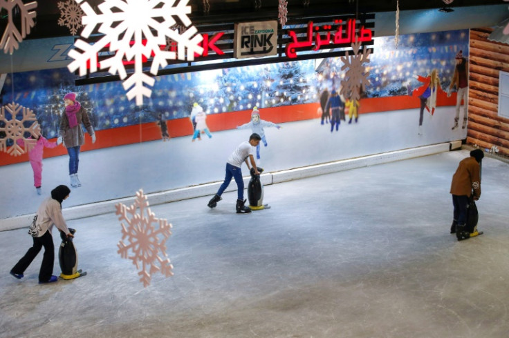 As night brings little relief from the sweltering gusts, residents of Baghdad flock to the city's lone indoor ice rink to find respite