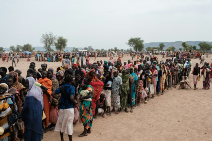 People line up to register for a potential food aid delivery at a camp for internally displaced persons in Agari, in Sudan's South Kordofan
