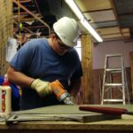 Nathaniel Blankenship, a crew member in a job program with Coalfield Development Corporation, works to remodel a 1920s-era warehouse into office space in Williamson, West Virginia.