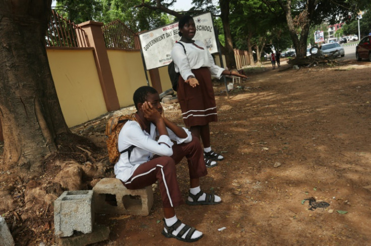 Students wait outside their Government Science Secondary School in the capital after unions launched an indefinite strike for a higher minimum wage