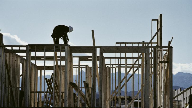 Worker working on the roof of a house under construction