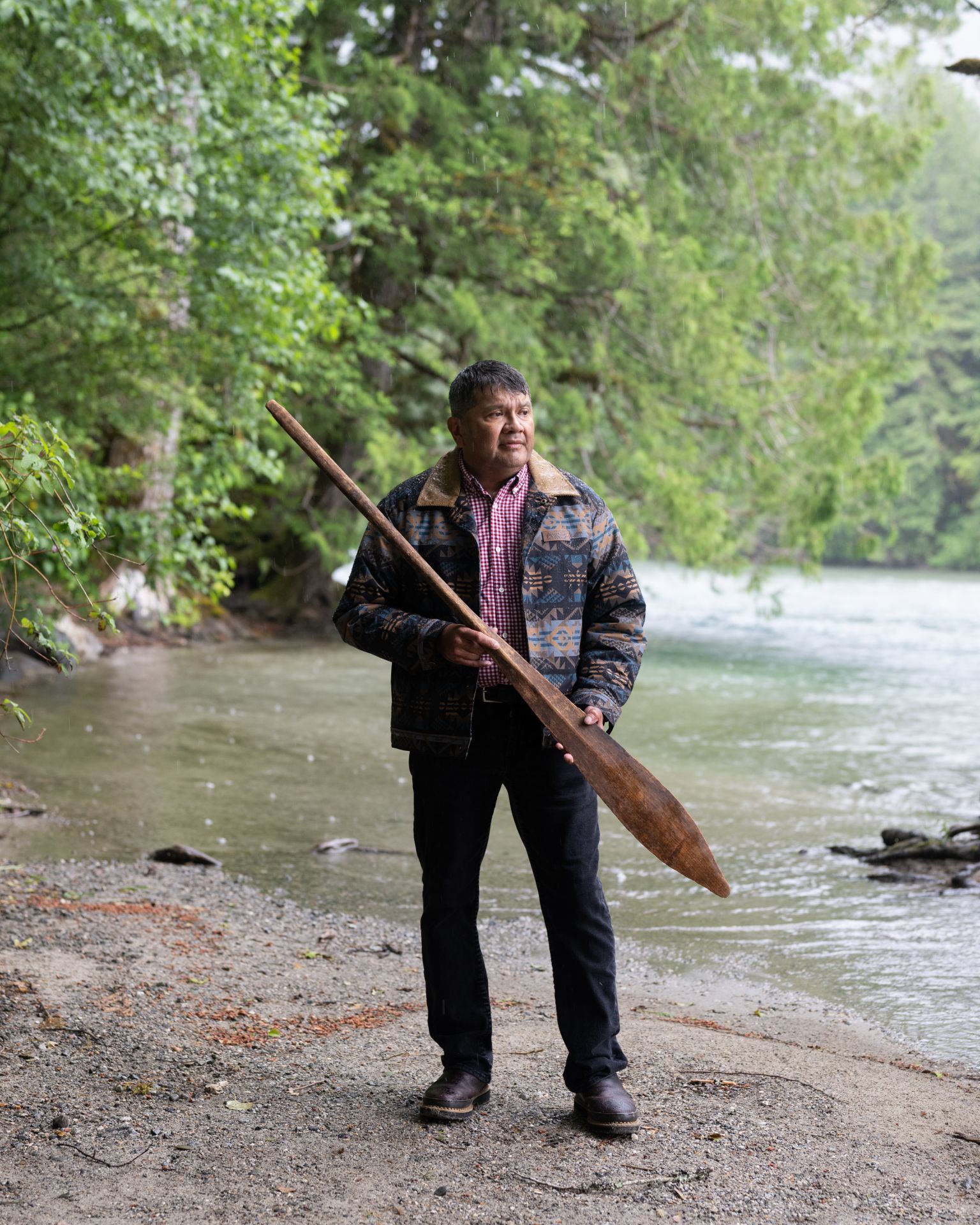 Scott Schuyler, Upper Skagit Tribe, holding an ancestral paddle.