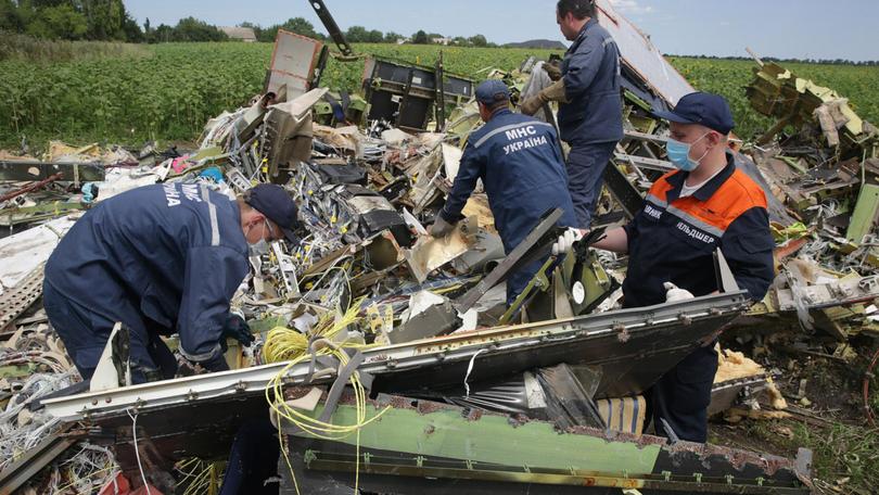 MHC local emergency workers angle grind into the remains of the cockpit of MH17 in 2022, following the downing of the plane by Russian operatives. Ella Pellegrini