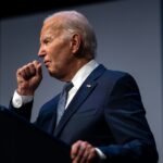 This photo taken on July 16, 2024 shows US President Joe Biden clearing his throat as he speaks on economics during the Vote To Live Properity Summit at the College of Southern Nevada in Las Vegas, Nevada. US President Joe Biden tested positive for Covid
