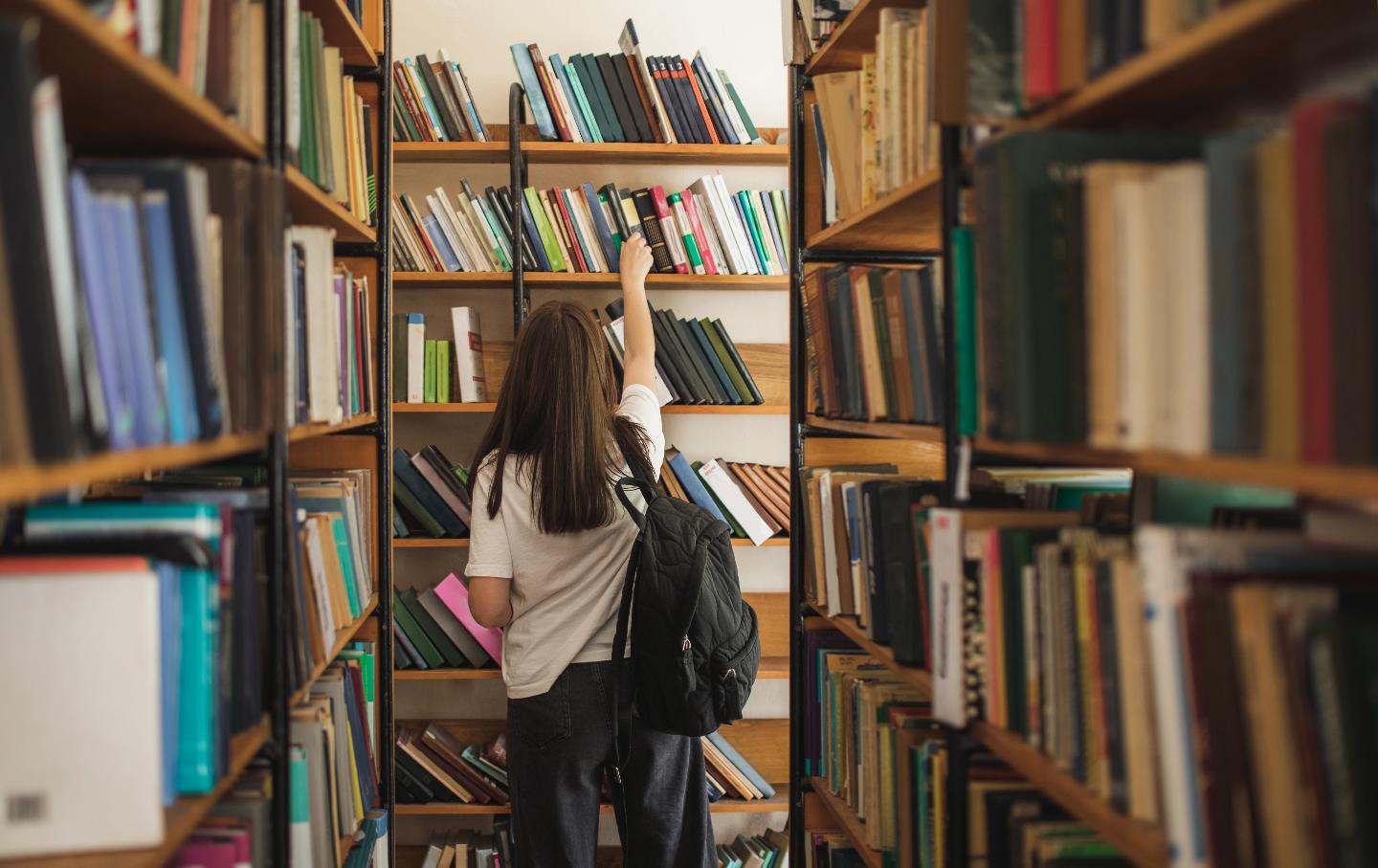A student looking for a book in a school library.