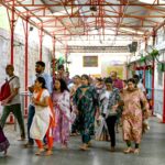 Hindu devotees walk around the inner chamber of Chilkur Balaji temple near  Hyderabad, many hoping the gods will look favourably on their US visa application