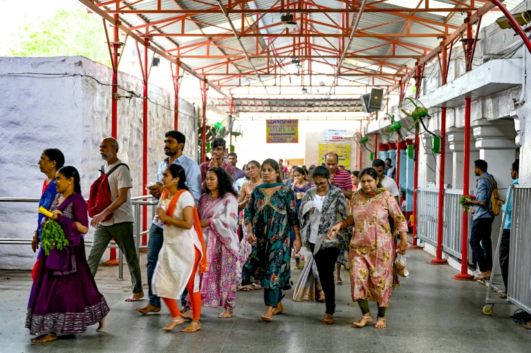 Hindu devotees walk around the inner chamber of Chilkur Balaji temple near  Hyderabad, many hoping the gods will look favourably on their US visa application