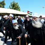 Elderly members of the Druze community gather in solidarity with the victims of the attack in Majdal Shams, in the Syrian town of Quneitra, close to the Israeli-annexed Golan Heights