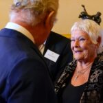 Britain's King Charles III speaks to actress Judi Dench, who has become one of the first female members of the Garrick Club