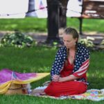 A person prays in a park in downtown Milwaukee, Wisconsin, on July 14, 2024 ahead of the Republican presidential convention