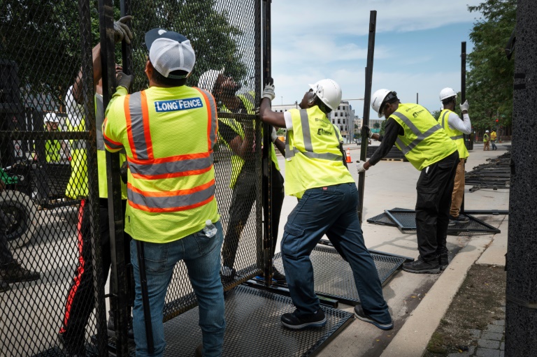 Workers install security fencing near the Fiserv Forum on July 10, 2024 in Milwaukee, Wisconsin