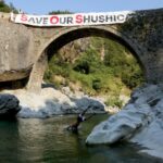 Residents and environmentalists take part in a protest against the construction of a water pipeline, at Brataj old bridge over the Shushica river, in the village of Brataj, near the Albanian city of Vlore