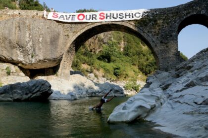 Residents and environmentalists take part in a protest against the construction of a water pipeline, at Brataj old bridge over the Shushica river, in the village of Brataj, near the Albanian city of Vlore