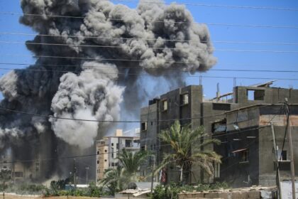 Smoke rises from a building hit by an Israeli strike in Nuseirat in the central Gaza Strip on July 20, 2024