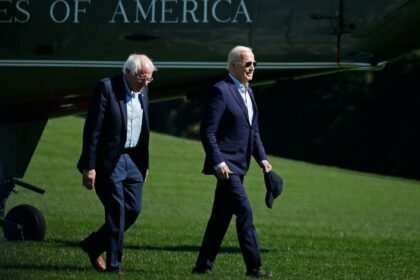 President Joe Biden and Senator Bernie Sanders (I-VT) walk across the South Lawn after returning to the White House on board the Marine One presidential helicopter on April 22, 2024, in Washington, DC.