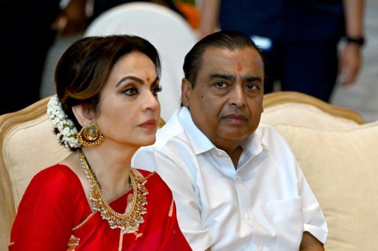 Billionaire tycoon and chairman of Reliance Industries Mukesh Ambani (R) with wife Nita