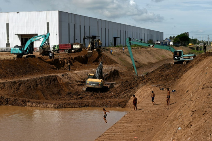 Children play next to the construction site of the Funan Techo canal along the Prek Takeo channel in Kandal province